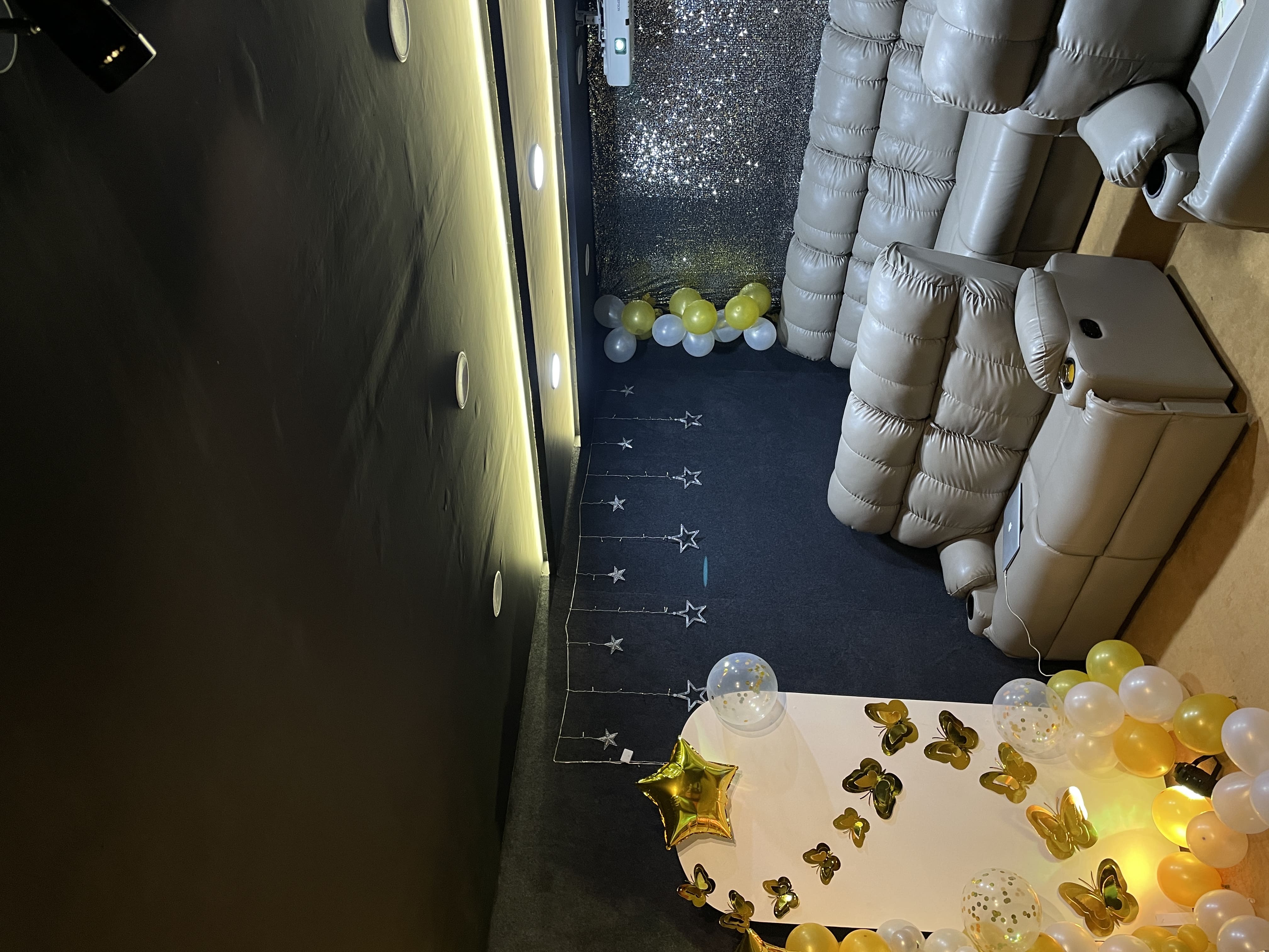 Two people decorating a Christmas tree with ornaments and a star